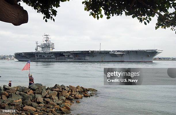This handout photo from the U.S. Navy shows family and friends of personnel aboard the USS Abraham Lincoln watching the ship enter San Diego Harbor...