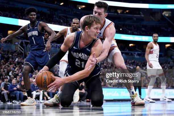 Moritz Wagner of the Orlando Magic controls the ball against Drew Eubanks of the Phoenix Suns during the third quarter at Kia Center on January 28,...