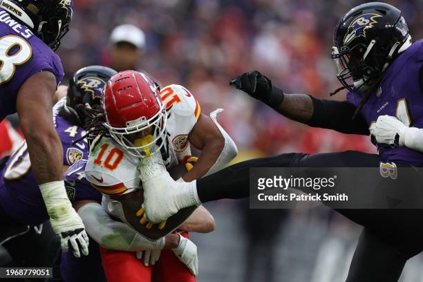 Isiah Pacheco of the Kansas City Chiefs is kicked by Jadeveon Clowney of the Baltimore Ravens during the second quarter in the AFC Championship Game...