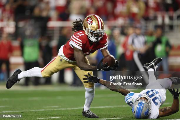 Brandon Aiyuk of the San Francisco 49ers catches a pass that was tipped by Kindle Vildor of the Detroit Lions during the third quarter in the NFC...