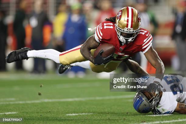 Brandon Aiyuk of the San Francisco 49ers catches a pass that was tipped by Kindle Vildor of the Detroit Lions during the third quarter in the NFC...
