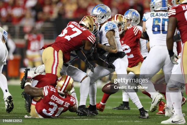 Tashaun Gipson Sr. #31 of the San Francisco 49ers forces a fumble by Jahmyr Gibbs of the Detroit Lions during the third quarter in the NFC...