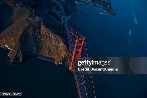 Aerial view of Golden Gate Bridge over bay at sunset