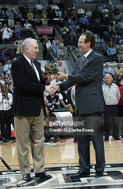Deputy Commissioner Russ Granik present Gregg Popovich of the San Antonio Spurs the Auerbach Trophy award for coach of the year, prior to the game...