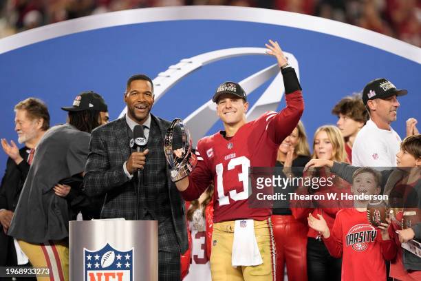 Brock Purdy of the San Francisco 49ers reacts as he holds the George Halas Trophy after defeating the Detroit Lions 34-31 in the NFC Championship...