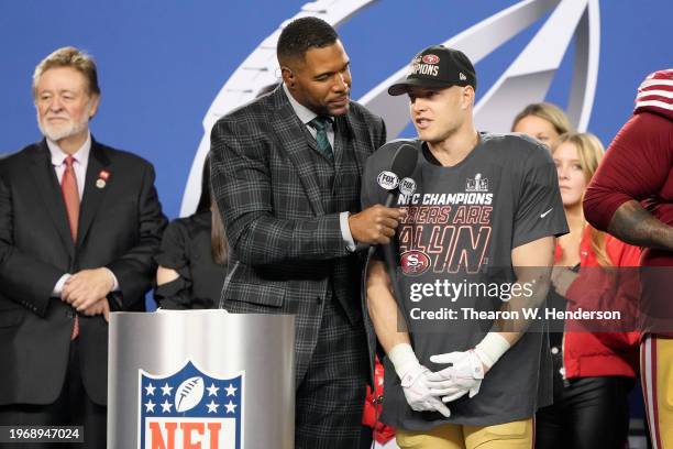 Christian McCaffrey of the San Francisco 49ers is interviewed by Fox commentator and former NFL player Michael Strahan after defeating the Detroit...
