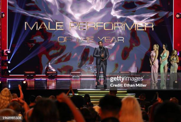 Isiah Maxwell accepts the Male Performer of the Year award as presenters Blake Blossom, Jennifer White and CJ Miles look on during the 2024 Adult...