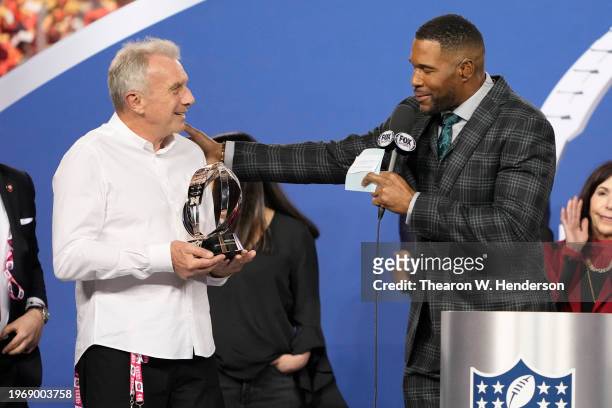 Hall of famer Joe Montana holds the George Halas Trophy as he talks with NFL commentator and former NFL player Michael Strahan after the San...