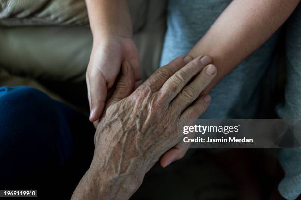 close up of grandson holding his mothers hands - family support stock pictures, royalty-free photos & images