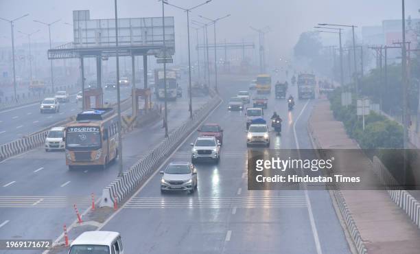 Commuters face tough driving conditions as a spell of light rain swept the Ghaziabad city since Wednesday afternoon at NH9 Dasna, on January 31, 2024...