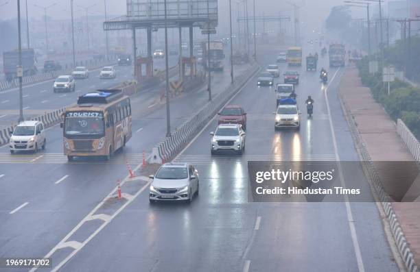 Commuters face tough driving conditions as a spell of light rain swept the Ghaziabad city since Wednesday afternoon at NH9 Dasna, on January 31, 2024...