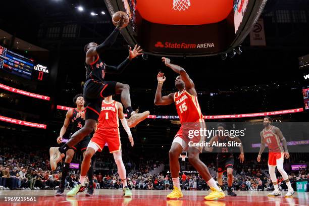Dennis Schroder of the Toronto Raptors shoots over Clint Capela of the Atlanta Hawks during the second half at State Farm Arena on January 28, 2024...