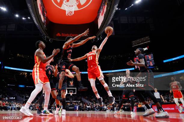 Trae Young of the Atlanta Hawks shoots against Thaddeus Young of the Toronto Raptors during the firhalf at State Farm Arena on January 28, 2024 in...