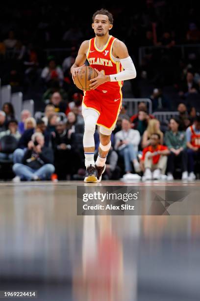 Trae Young of the Atlanta Hawks drives down court against the Toronto Raptors during the first half at State Farm Arena on January 28, 2024 in...