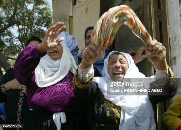 Unidentified relatives of 17-year-old Mutassem Nassir weep during his funeral 20 April 2004 in Beit Hanun in the northern Gaza strip. Three...