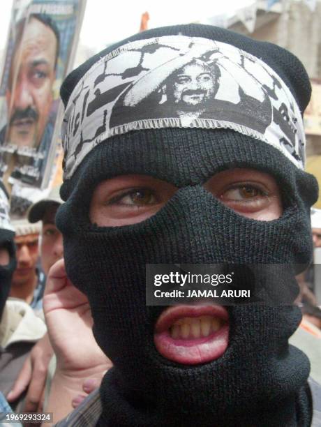 Masked Palestinian demonstrator takes part in a protest in support of Palestinian leader Marwan Barghuti , in the West Bank city of Ramallah, 15...