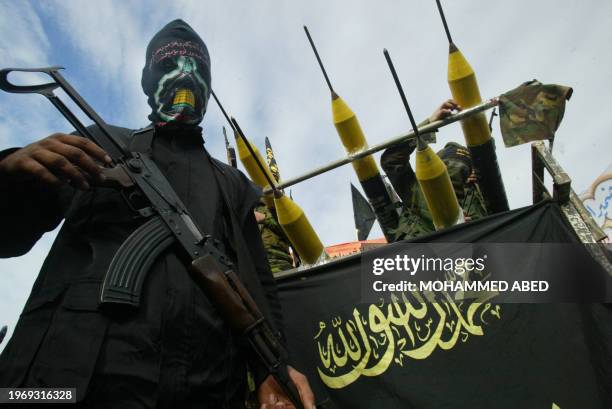 Masked members of Islamic Jihad's armed wing Saraya al-Quds, or Jerusalem Battalions, parade in Jabalia refugee camp in the northern Gaza Strip, 02...