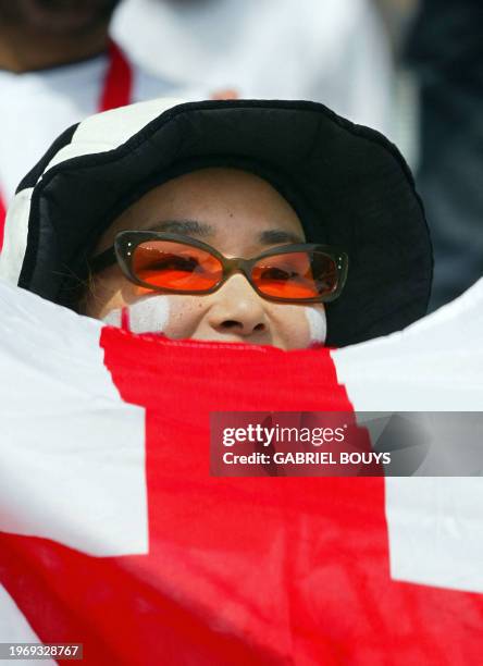 Supporter of the English team holds a flag 12 June, 2002 before match 38 group F of the 2002 FIFA World Cup Korea Japan opposing Nigeria and England...