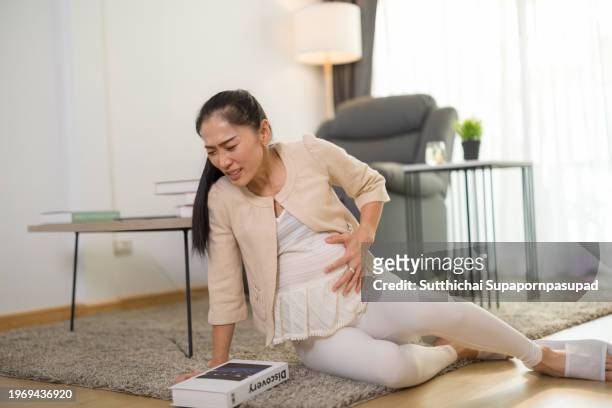 asian pregnant woman facing an unfortunate slip and falling down in living room  accident at home. - petticoat stock pictures, royalty-free photos & images