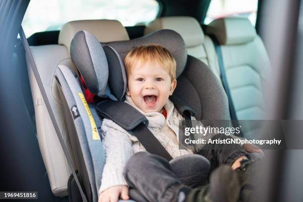 excited little boy ready for a road trip. - childs seat stock pictures, royalty-free photos & images