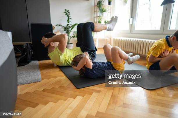 family enjoying home workout - dad press ups kids stock pictures, royalty-free photos & images