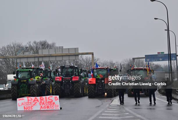 Protesting farmers blockade the A6 autoroute with tractors on February 1, 2024 in Chilly-Mazarin, France. French farmers choked off main highways...