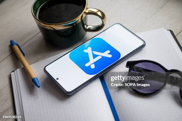 In this photo illustration an Apple App Store logo seen displayed on a smartphone.