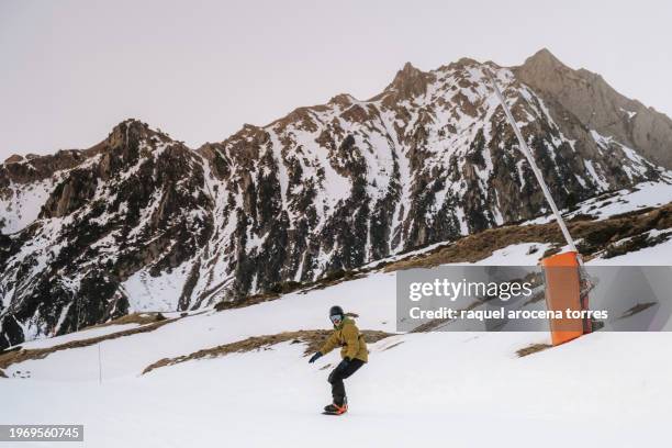 front view of an adult man snowboarding - nevada winter stock pictures, royalty-free photos & images