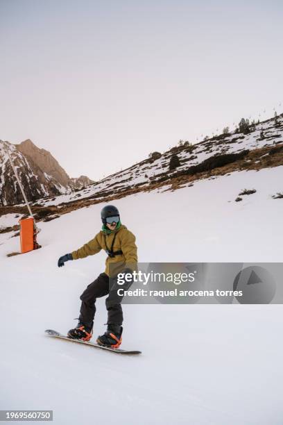 front view of an adult man snowboarding - nevada winter stock pictures, royalty-free photos & images