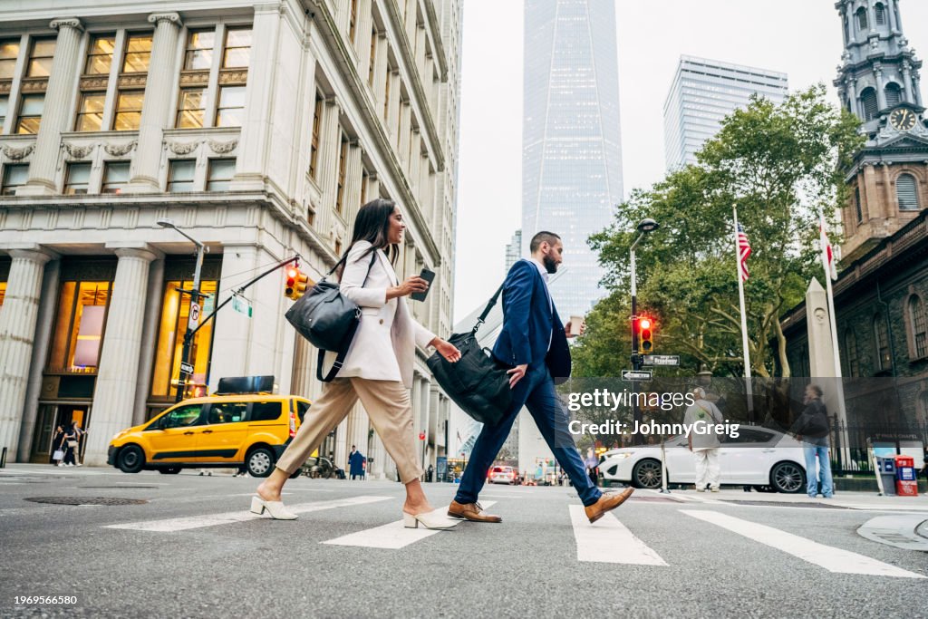 Profesionales de negocios de Nueva York cruzando Fulton en Broadway