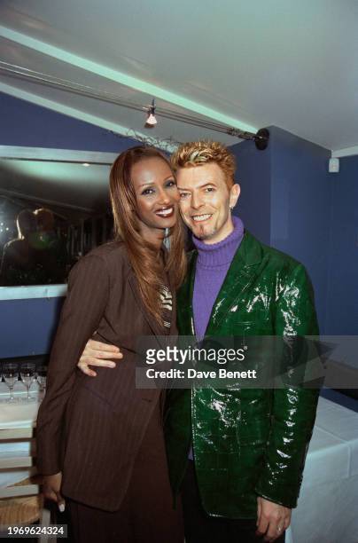 English singer David Bowie and Somali–American model Iman attend an event at Legends nightclub to celebrate a worldwide licensing deal with EMI Music...