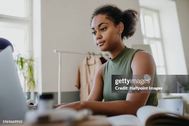 teenage girl studying at home, doing homework while wearing continuous glucose monitor at arm. - smoking patch stock pictures, royalty-free photos & images