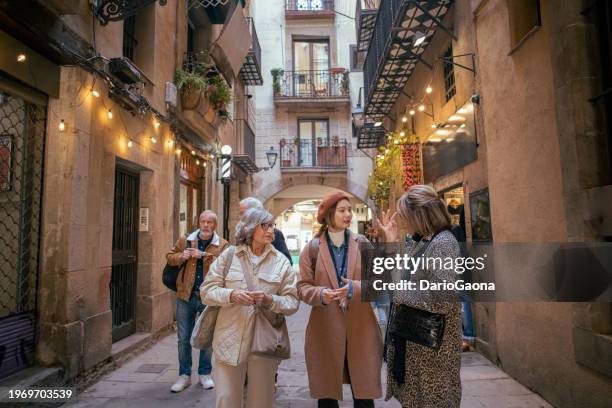 senior friends with a tour guide at the city - southern european descent stock pictures, royalty-free photos & images