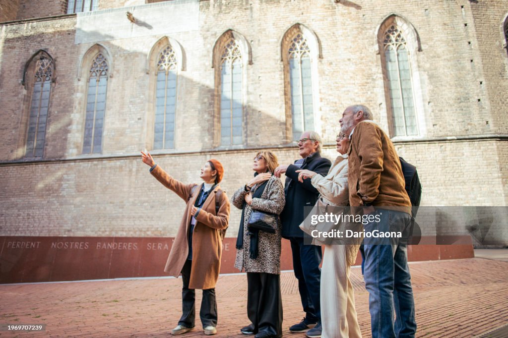 Senior friends with a tour guide at the city