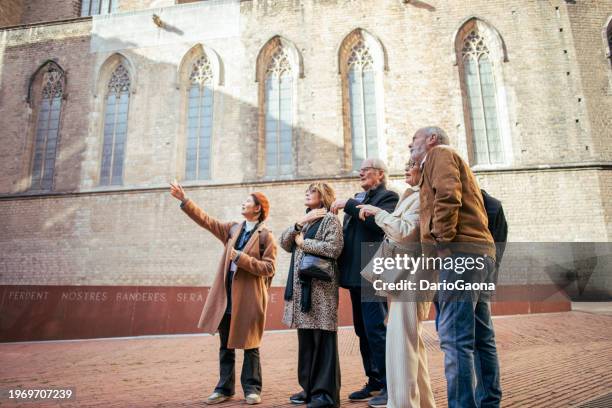 senior friends with a tour guide at the city - exploration stock pictures, royalty-free photos & images
