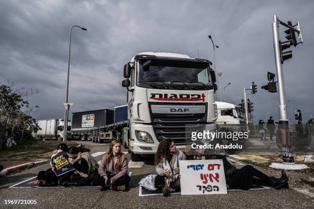Some of Jewish protestors, belonged to 'Hill Youth' group, sit on the ground and in front of the trucks, trying to reach the port and block the...