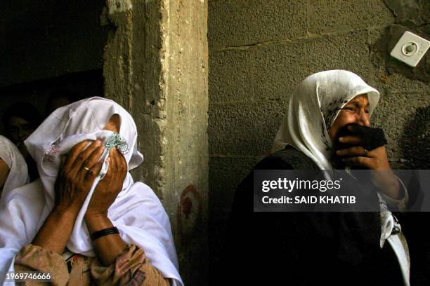 Palestinian women mourn during the funeral of Ahmad Abu Eid in the Khan Yunis refugee camp in the southern Gaza Strip, 30 June 2004. Abu Obeid was...