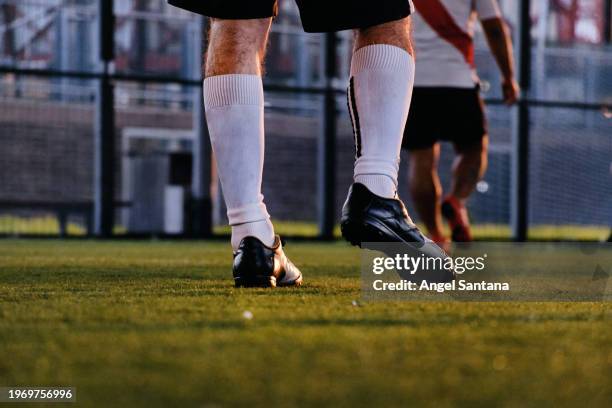 close-up of soccer player's legs on field - two human feet stock pictures, royalty-free photos & images