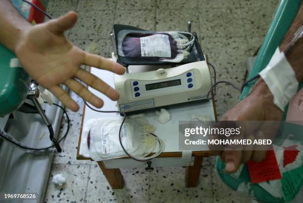 Palestinians donate blood at al-Shifa hospital following a firefight with Israeli forces 11 February 2004 in Gaza City. Thirteen Palestinians were...