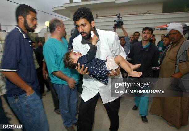 Palestinian medic carries a wounded child into al-Najar hospital following a rocket attack by an Israeli helicopter gunship in the southern Gaza...