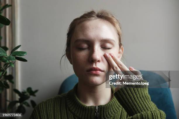 emotional freedom technique. calm peaceful woman touching face with with fingertips, keeping eyes closed, practicing eft tapping to relieve stress, anxiety or pain - pressure point stock pictures, royalty-free photos & images