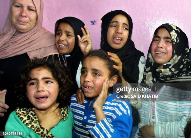 Relatives of eight-year-old Palestinian Hussein Abu Akar mourn his death 02 May 2004 at the family house in the Khan Yunis refugee camp in the...