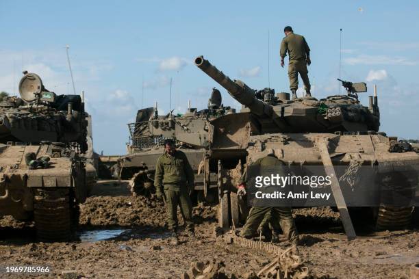 Israeli soldiers fix a tank's tracks near the border with Gaza on February 1, 2024 in Southern Israel, Israel. The Israeli prime minister's office...