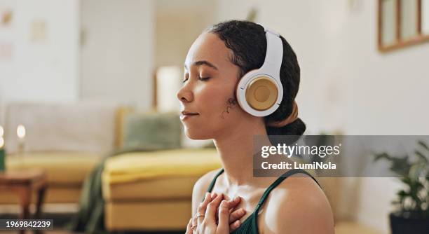 woman, meditation and yoga in headphones listening to calm music, holistic exercise and peace in living room. young person with audio podcast, dream of health and relax in spiritual wellness at home - saúde mental imagens e fotografias de stock