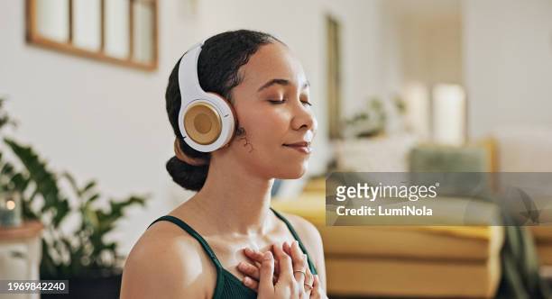 meditation, woman with hands on chest with headphones for mindfulness and zen, wellness and healing with tech. yoga, listening to music or podcast for self care, holistic exercise and calm at home - woman flat chest 個照片及圖片檔