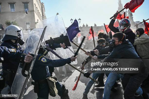 Students clash with riot police in front of the Greek Parliament during a demonstration against the government's plans for private universities, in...