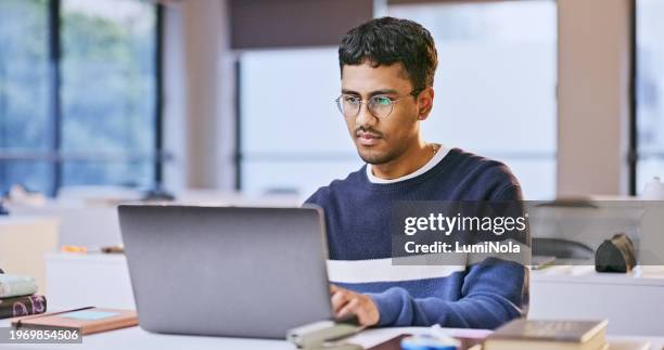 laptop, university classroom and man reading online research study on history information, knowledge or education. school project, analysis and indian student learning course for college development - asian-students-classroom-computer stock pictures, royalty-free photos & images