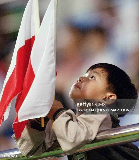 Young South Korean boy holds up two Polish flags ahead of the Poland-USA Group D match at the 2002 FIFA World Cup Korea/Japan in Daejeon, 14 June...