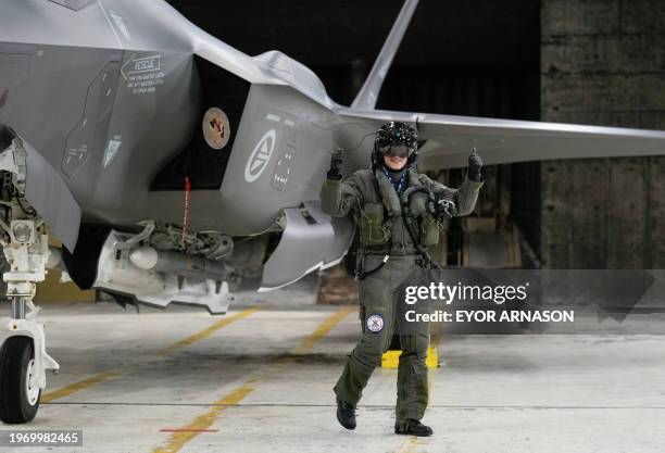 Pilot reacts next to a Norwegian F-35 fighter parked in a hangar at Keflavik Air Base in Iceland on February 1, 2024. Iceland does not maintain an...