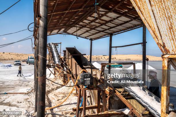 Workers at the salt ponds at Bardawel lake near Bir al-Abed on January 29, 2024 in North Sinai, Egypt. Egyptian salt producers in North Sinai are...